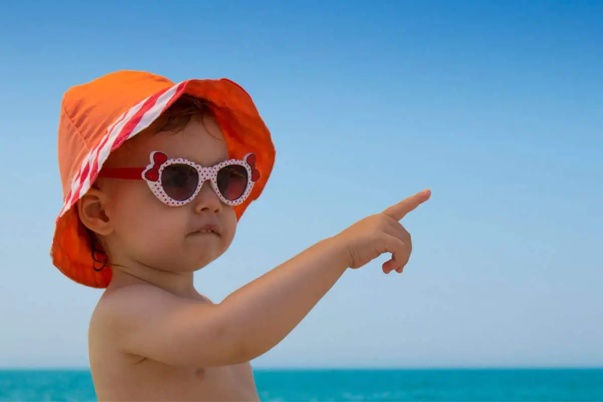 Bébé avec des lunettes de soleil à la plage